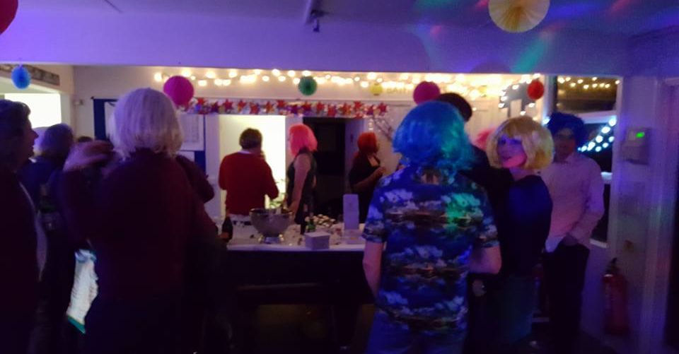 A community gathering and party in the clubhouse at Bath Tennis