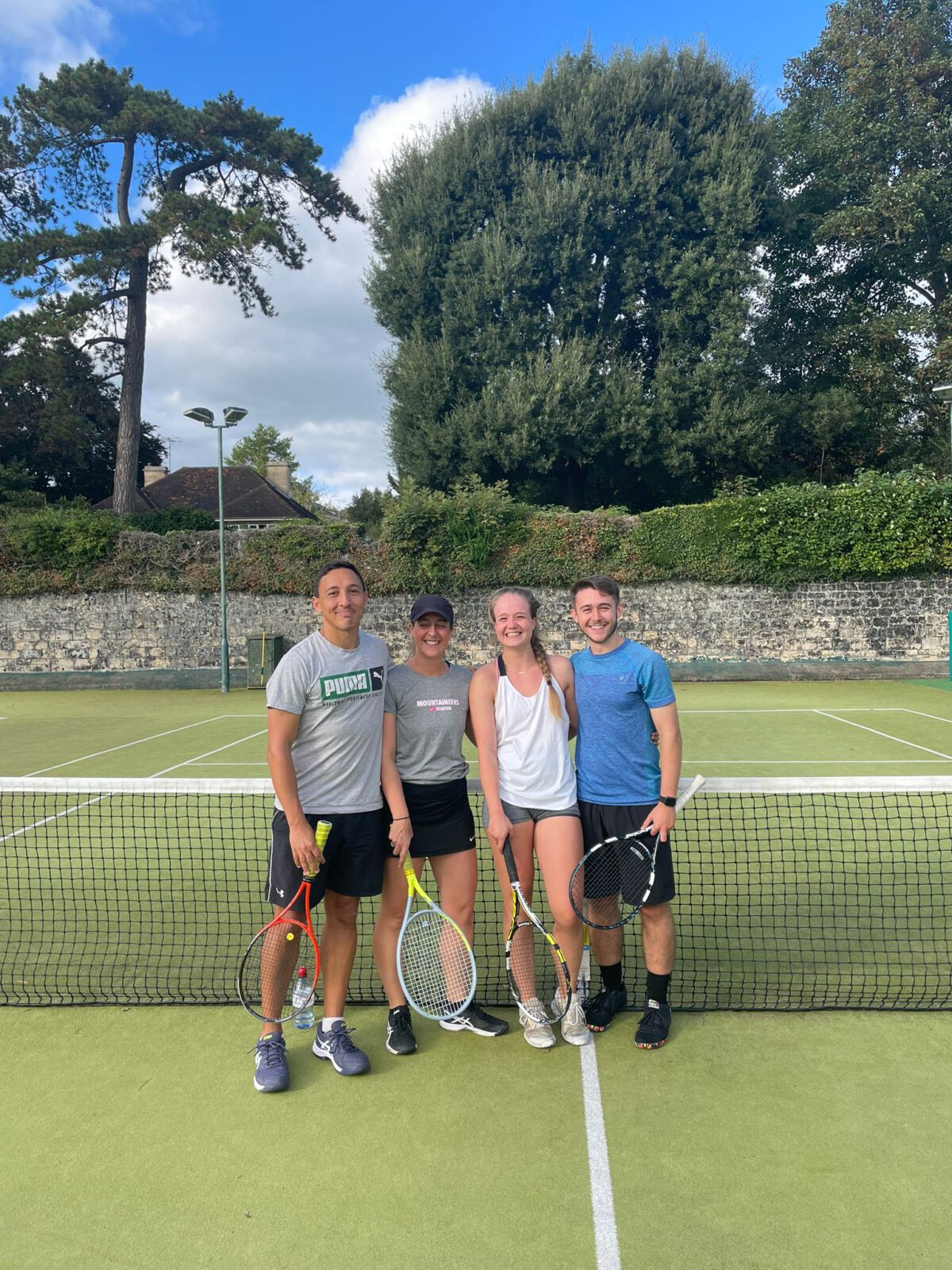 2 mixed doubles tennis partners after a tennis match on an astroturf tennis court at Bath Tennis