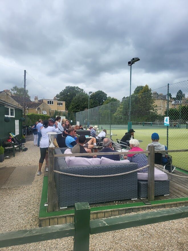 Spectators next to the Bath Tennis clubhouse opposite Victoria Park watching tennis matches at Bath Tennis